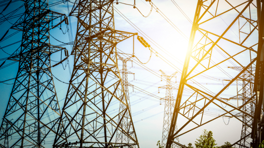 High-voltage electrical grid infrastructure with power lines.